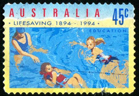 AUSTRALIA - CIRCA 1994: stamp printed by Australia, shows Children swim in the pool, circa 1994の写真素材