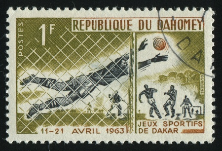 DAHOMEY - CIRCA 1963: stamp printed by Dahomey, shows soccer players and ball, circa 1963.の写真素材