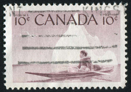 CANADA - CIRCA 1955: stamp printed by Canada, shows Eskimo and Kayak, circa 1955の写真素材