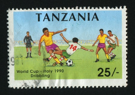 TANZANIA - CIRCA 1990: stamp printed by Tanzania,  shows soccer players and ball, circa 1990.の写真素材