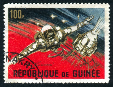 GUINEA - CIRCA 1965:   stamp printed by Guinea,  shows American and Russian achievements in space, circa 1965.の写真素材
