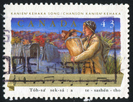 CANADA - CIRCA 1993: stamp printed by Canada, shows Folk Songs, Indian woman, circa 1993の写真素材