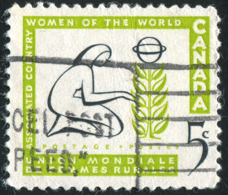 CANADA - CIRCA 1959: stamp printed by Canada, shows Woman Tending Tree, circa 1959の写真素材