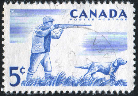 CANADA - CIRCA 1957: stamp printed by Canada, shows Hunter and dog, circa 1957の写真素材