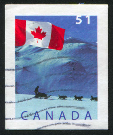 CANADA - CIRCA 2005: stamp printed by Canada, shows Flag and Dogsled, Yukon territory, circa 2005の写真素材