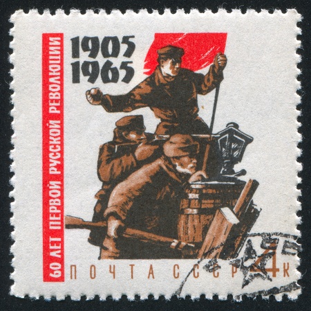 RUSSIA - CIRCA 1965: stamp printed by Russia, shows Fighters on barricades with red flag, circa 1965の写真素材