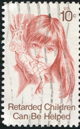 UNITED STATES - CIRCA 1974: stamp printed by United States, shows a retarded girl touching woman hand, circa 1974のeditorial素材