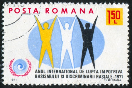 ROMANIA - CIRCA 1971: stamp printed by Romania, shows emblem of International Year against racism, circa 1971vの写真素材