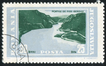 ROMANIA - CIRCA 1965: stamp printed by Romania, Yugoslavia shows IIron Gate, Danub, circa 1965の写真素材