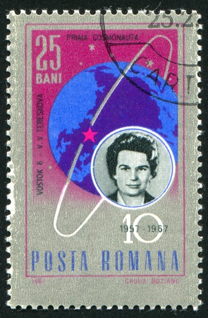ROMANIA - CIRCA 1967: stamp printed by Romania, shows Valentina Tereshkova and globe with trajectory of Vostok 6, circa 1967のeditorial素材