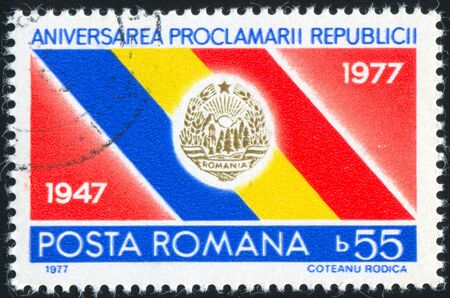 ROMANIA - CIRCA 1977: stamp printed by Romania, shows Flag and Arms of Romania, circa 1977の写真素材