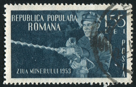 ROMANIA - CIRCA 1953: stamp printed by Romania, shows Miner Using Drill, circa 1953のeditorial素材