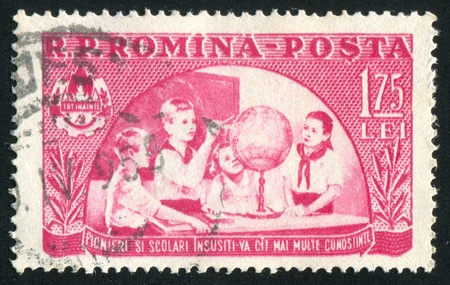 ROMANIA - CIRCA 1954: stamp printed by Romania, shows Young students, circa 1954のeditorial素材