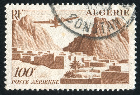 ALGERIA CIRCA 1949: stamp printed by Algeria, shows Plane over Village, circa 1949の写真素材