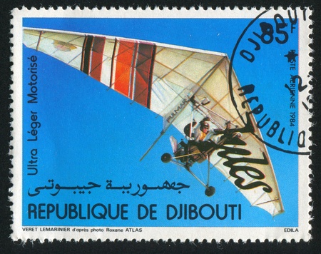 DJIBOUTI - CIRCA 1984: stamp printed by Djibouti, shows Motorized Hang Gliders, circa 1984の写真素材