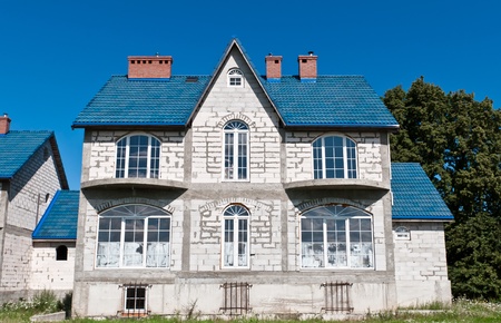 Kaliningrad region. Russia. A house with a blue roof. Sunny summer day.のeditorial素材