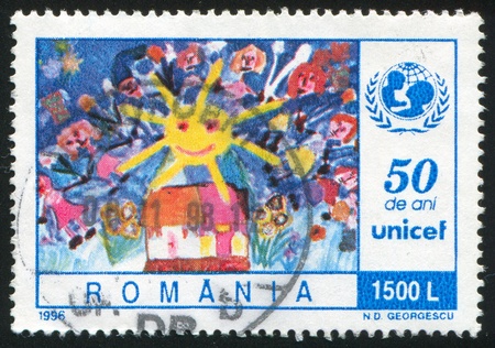 ROMANIA - CIRCA 1996: stamp printed by Romania, shows Childrenâs painting, Children and Sun over House, circa 1996の写真素材