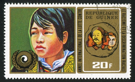 GUINEA - CIRCA 1972:   stamp printed by Guinea,  shows Oriental boy, circa 1972.のeditorial素材