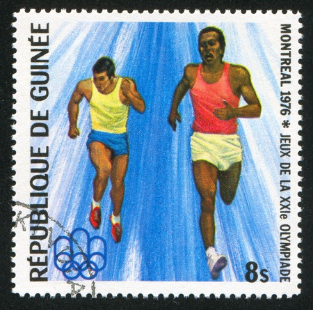 GUINEA - CIRCA 1976:   stamp printed by Guinea,  shows runner, circa 1976.のeditorial素材