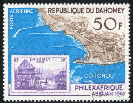 DAHOMEY CIRCA 1969: stamp printed by Dahomey, shows Dahomey and aerial view of Cotonou, circa 1969の写真素材