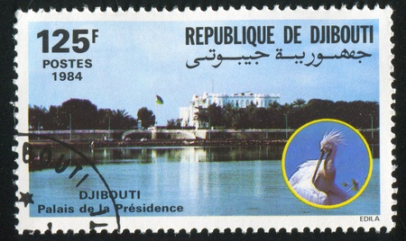 DJIBOUTI CIRCA 1984: stamp printed by Djibouti, shows Presidential Palace, bird, circa 1984の写真素材