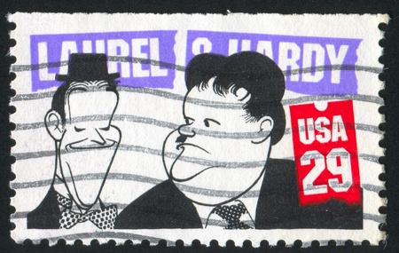 UNITED STATES - CIRCA 1991: stamp printed by United States of America, shows caricature of Laurel and O`Hardy, circa 1991のeditorial素材