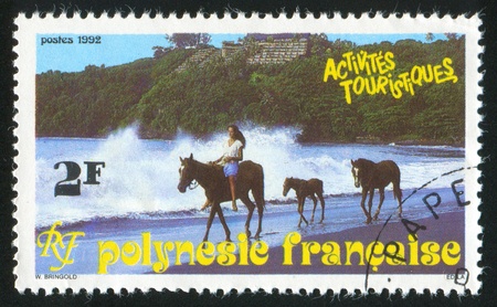 FRENCH POLYNESIA CIRCA 1992: stamp printed by French Polynesia, shows Horses, beach, circa 1992の写真素材