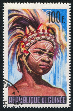 GUINEA CIRCA 1980: stamp printed by Guinea, shows Boy in national costume, circa 1980の写真素材