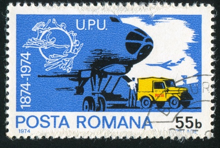 ROMANIA - CIRCA 1974: stamp printed by Romania, shows post car, circa 1974の写真素材