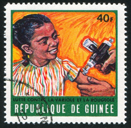 GUINEA CIRCA 1970: stamp printed by Guinea, shows Girl receiving vaccination, circa 1970の写真素材