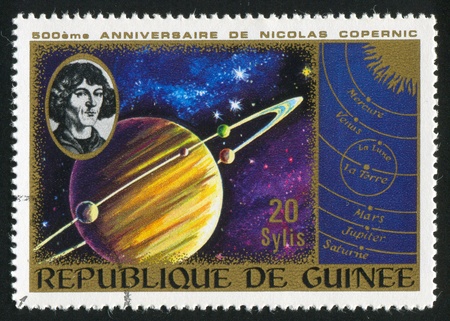 GUINEA CIRCA 1973: stamp printed by Guinea, shows Saturn and heliocentric system, circa 1973
