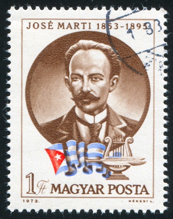 HUNGARY - CIRCA 1973: stamp printed by Hungary, shows Jose Marti and Cuban Flag, circa 1973のeditorial素材