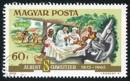 HUNGARY - CIRCA 1975: stamp printed by Hungary, shows Dr. Schweitzer, patient and microscope, circa 1975の写真素材