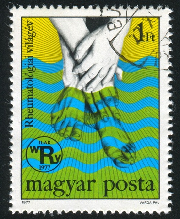 HUNGARY - CIRCA 1977: stamp printed by Hungary, shows Hands and Feet Bathed in Thermal Spring, circa 1977の写真素材