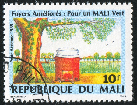 MALI CIRCA 1989: stamp printed by Mali, shows Furnace, tree, field, circa 1989の写真素材
