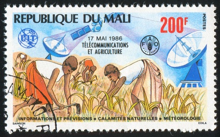 MALI - CIRCA 1986: stamp printed by Mali, shows Telecommunications and Agriculture, circa 1986の写真素材