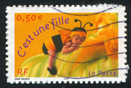 FRANCE - CIRCA 2001: stamp printed by France, shows girl-bumblebee, circa 2001のeditorial素材