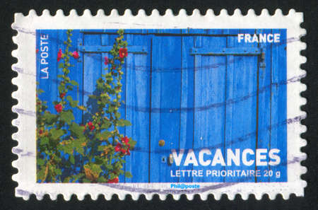 FRANCE - CIRCA 2007: stamp printed by France, shows wooden fence and hoollyhooks, circa 2007の写真素材