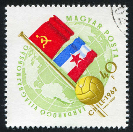 HUNGARY â CIRCA 1962: stamp printed by Hungary, shows flags of USSR and Jugoslavia and soccerball, circa 1962のeditorial素材