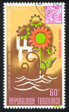 TOGO - CIRCA 1968: stamp printed by Togo, shows Water Cycle, Flower and Cogwheels, circa 1968のeditorial素材