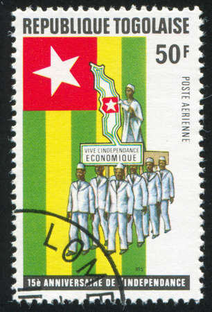 TOGO - CIRCA 1975: stamp printed by Togo, shows Parade, flag and map of Togo, circa 1975のeditorial素材