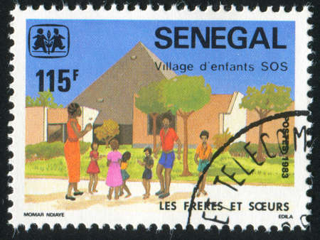 SENEGAL - CIRCA 1984: stamp printed by Senegal, shows Brothers and sisters, circa 1984のeditorial素材