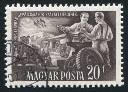 HUNGARY- CIRCA 1951: stamp printed by Hungary, shows tractor manufacture, circa 1951のeditorial素材