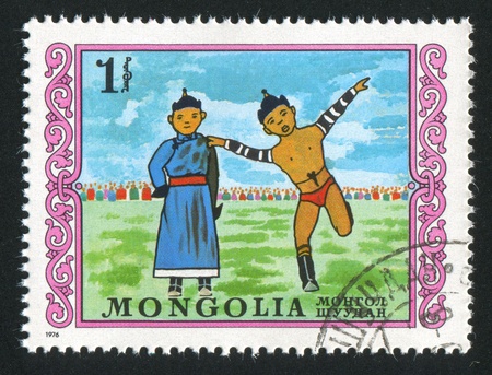 MONGOLIA - CIRCA 1976: stamp printed by Mongolia, shows mongolian wresting, perfomance, circa 1976の写真素材