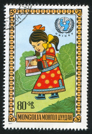 MONGOLIA - CIRCA 1977: stamp printed by Mongolia, shows Girl carrying bucket, circa 1977の写真素材