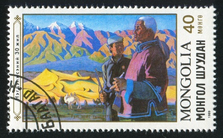 MONGOLIA - CIRCA 1989: stamp printed by Mongolia, shows Two men, mountains, Bactrian camels, circa 1989のeditorial素材