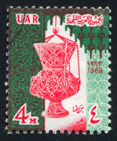 EGYPT - CIRCA 1962: stamp printed by Egypt, shows Eagle of Saladin over Cairo, circa 1962.のeditorial素材