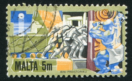 MALTA - CIRCA 1981: stamp printed by Malta, shows Men Hauling Building Stone, circa 1981のeditorial素材