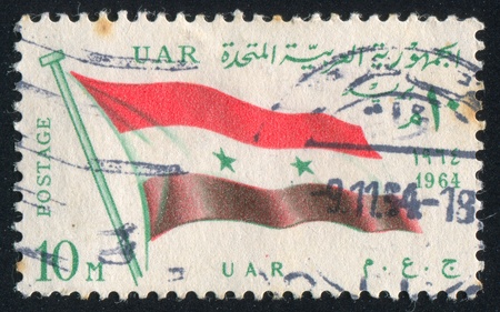 EGYPT - CIRCA 1964: stamp printed by Egypt, shows flag UAR, circa 1964.のeditorial素材