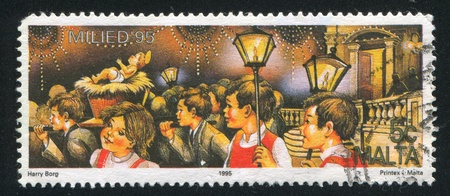 MALTA - CIRCA 1995: stamp printed by Malta, shows Christmas Eve, Children's Procession, circa 1995のeditorial素材